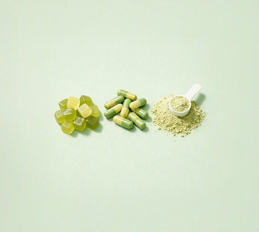 Three forms of dietary supplements: yellow gummy vitamins, green and yellow capsules, and fine powder with measuring spoon